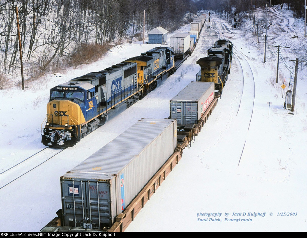 CSX SD70MAC 725, leads westbound Q137 and makes a meet with Q138 on the ex-B&O Keystone sub at, Sand Patch, Pennsylvania. January 25, 2003. 